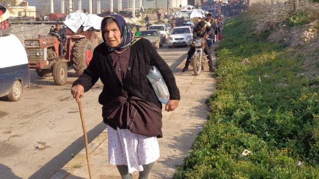An elderly woman joins a caravan of displaced people during the joint offensive by Ankara and Islamist militias against the Kurdish-Syrian enclave of Afrin, in January 2018. Only 20% of the original population remains in the occupied zone today. Credit: HH/IPS