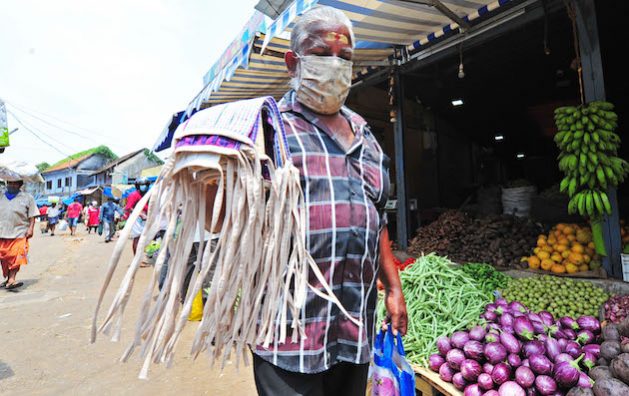 A mask seller in an Indian food market in Kerala during a recent zoonotic disease outbreak. COP28 is the first climate negotiation where the majority of the countries have agreed to declare their commitment to prevent the worsening health impacts of climate change. Credit: Stella Paul/IPS