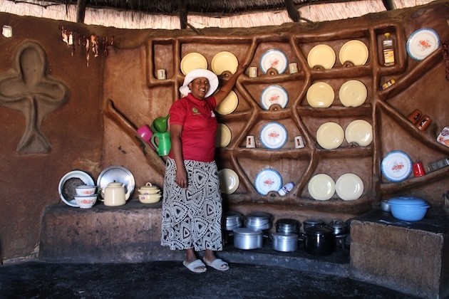 Sehlisiwe Sibanda inside her kitchen. She says her kitchen is pleasant to work in because of an energy-efficient stove that does not emit a lot of smoke. Credit: Busani Bafana/IPS