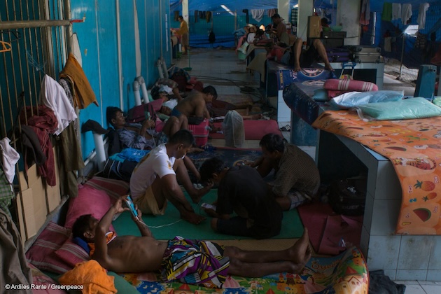 Burmese fishermen in temporary shelter in Ambon port, Indonesia. Hundreds of trafficked workers are waiting to be sent back home, with many facing an uncertain future. The forced labour and trafficking survivors interviewed by Greenpeace Southeast Asia detailed beatings and food deprivation for anyone who tried to escape. The tuna fishermen on their vessels were forced to work 20-22 hour days for little to no pay, often deprived of basic necessities like showers.