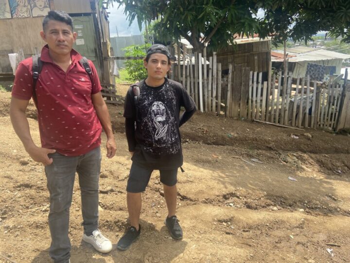 Lorenzo and his teenage son Carlos are photographed on one of the unpaved streets of Monte Sinai, a low-income neighborhood in northwest Guayaquil, which they had to flee because of threats and extortion by criminal gangs in the area. CREDIT: Carolina Loza León / IPS
