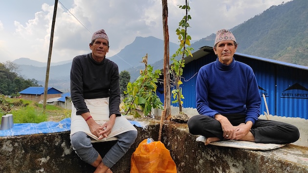 Sambhunath Guragain (right) and his family lost their agricultural land and it’s been three years since they have been able to grow any crops. Credit: Tanka Dhakal/IPS
